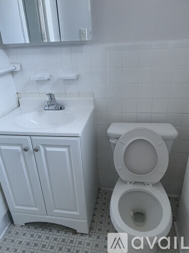 A white toilet sits next to a sink in a bathroom.