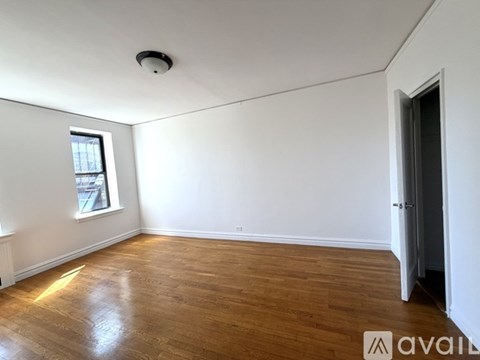 A room with wooden floors and white walls with a logo that reads "AVAIL".