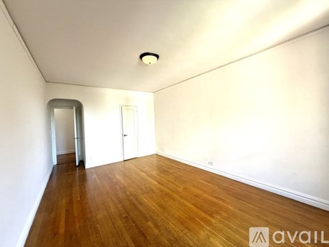 A room with wooden floors and two white doors.