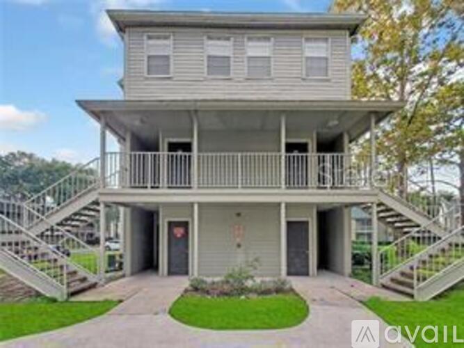 A two-story house with a balcony on the second floor.