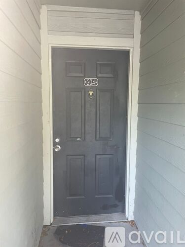 A black door with the number 2049 on it.