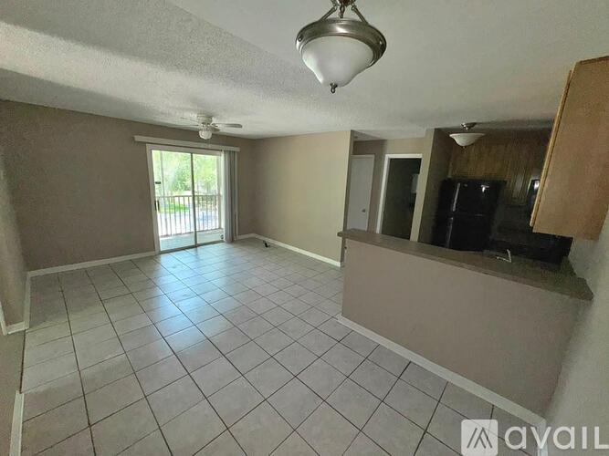 A living room with a sliding glass door leading to a balcony.