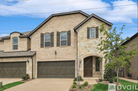 A house with a stone facade and a large garage door.
