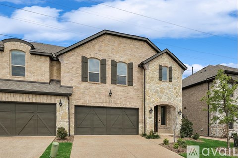 A house with a garage and a driveway in front.