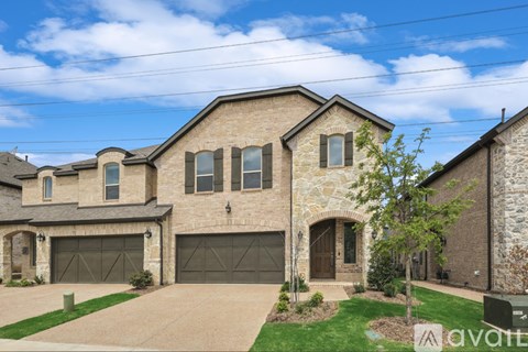 A house with a stone facade and a garage door.