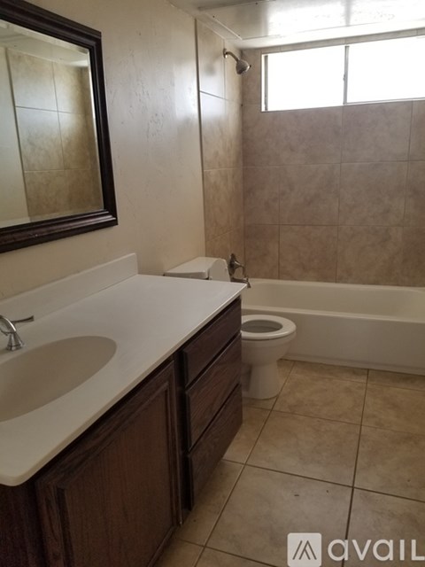 A bathroom with a sink, toilet and tub.
