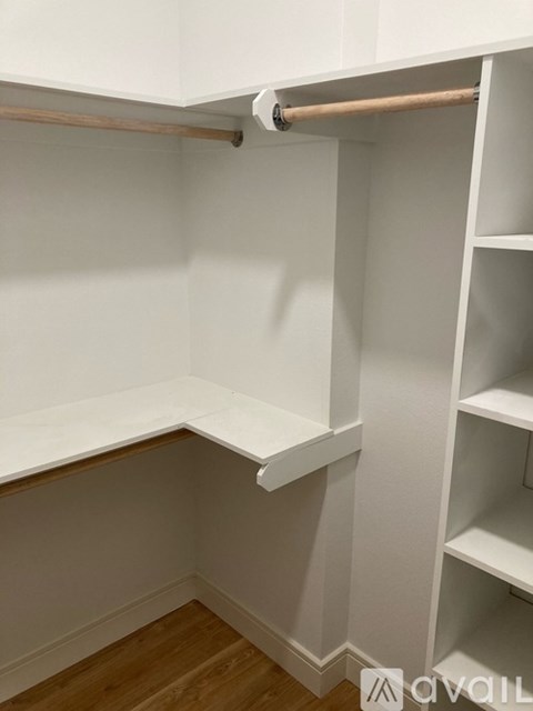 A white closet with shelves and a hanging rod.