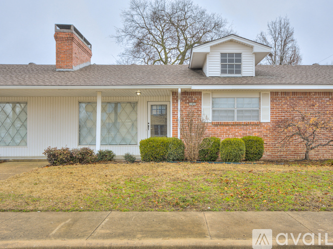 A house with a brick facade and a white roof.