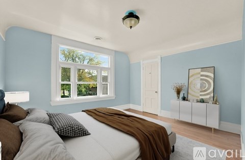 A bedroom with a large bed and a window.
