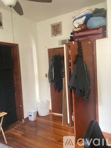 A room with a wooden floor and a white ceiling fan.