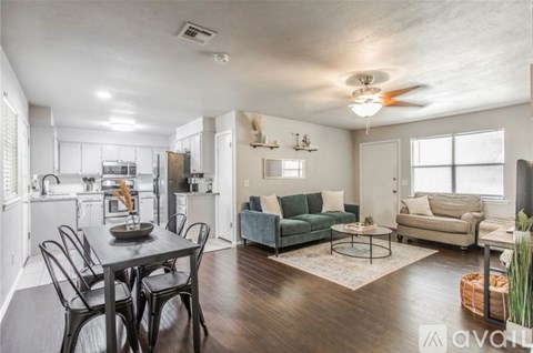 A well-lit, spacious kitchen and dining area with a table set for four.