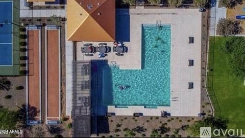 A large swimming pool in the middle of a grassy area.