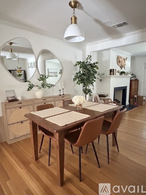 A dining room with a wooden table and chairs.
