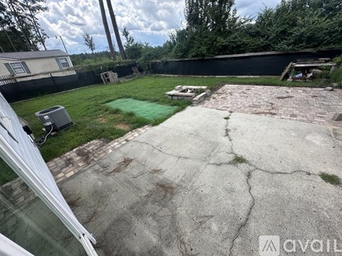 A backyard with a patio and a pool table.