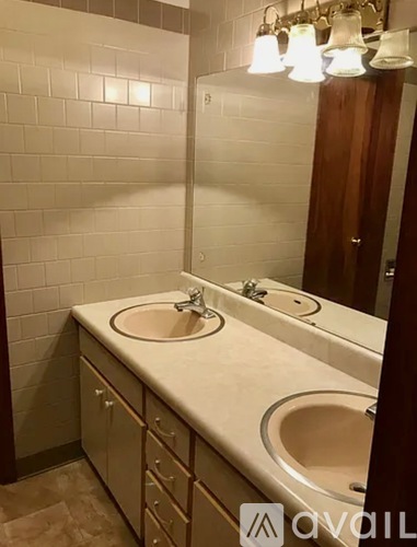 A bathroom with two sinks and a mirror.