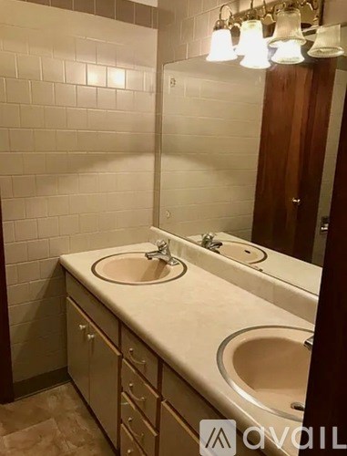A bathroom with two sinks and a mirror.