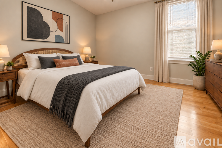 A bedroom with a large bed and a painting on the wall.