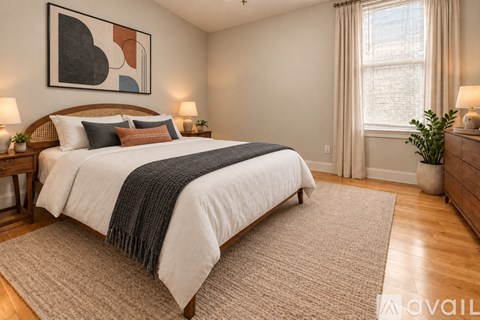 A bedroom with a large bed and a painting on the wall.