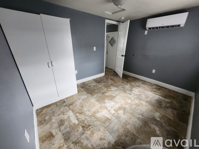 A room with a tiled floor and a white door.