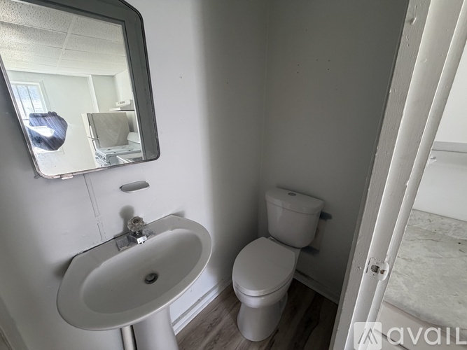 A bathroom with a white toilet and sink.
