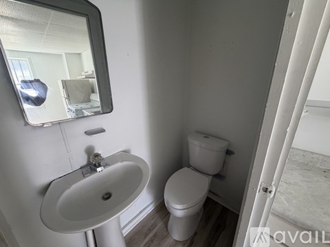 A bathroom with a white toilet and sink.