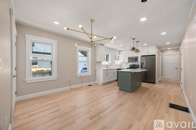 A spacious kitchen with wooden floors and a large island.