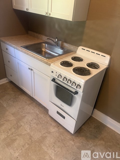 A white stove and sink in a kitchen.