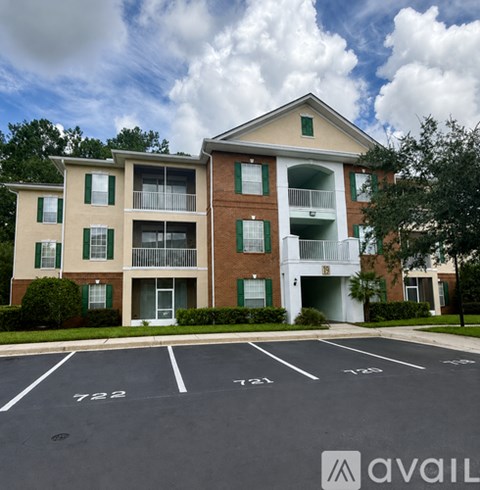 Apartment building with green shutters and a white garage door.