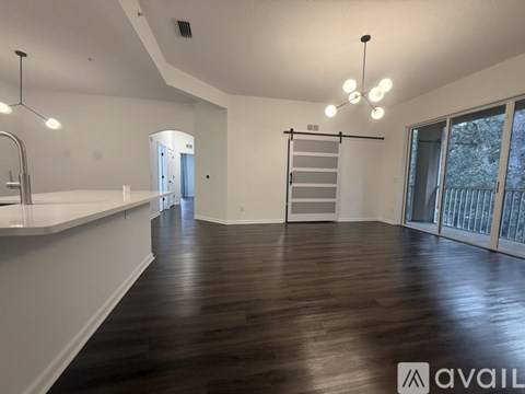 A spacious room with wooden flooring and a white countertop.