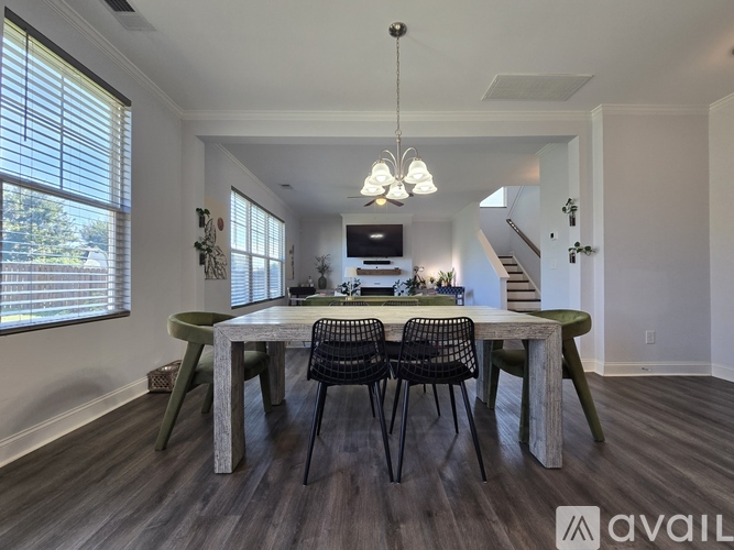 A dining room with a wooden table and chairs.