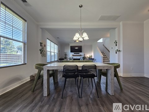 A dining room with a wooden table and chairs.