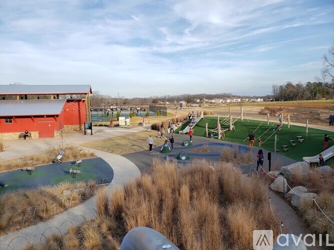 A playground with a slide, swings, and a basketball court.