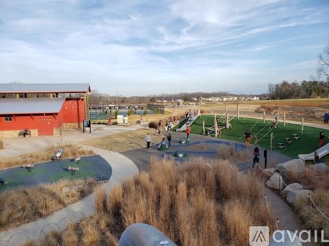 A playground with a slide, swings, and a basketball court.
