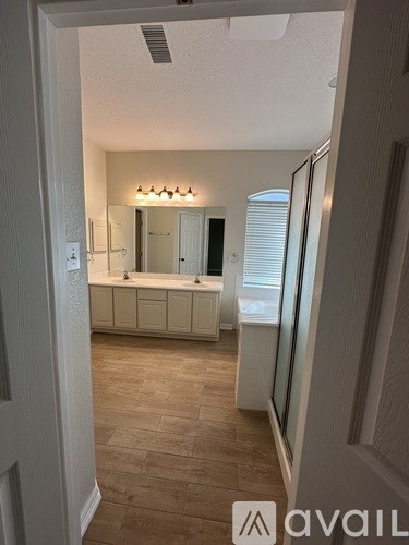 A bathroom with a sink, mirror, and tiled floor.