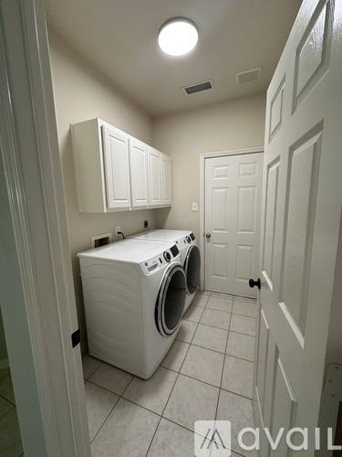 A small laundry room with a washer and dryer.