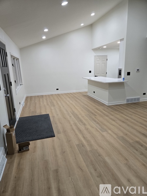 A room with wooden flooring and a white counter.