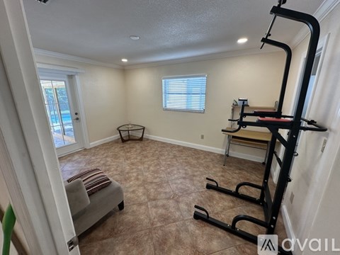A room with a gym equipment set up.
