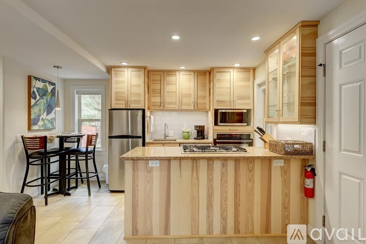 A kitchen with wooden cabinets and a central island.