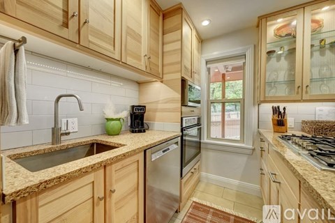 A kitchen with wooden cabinets and granite countertops.