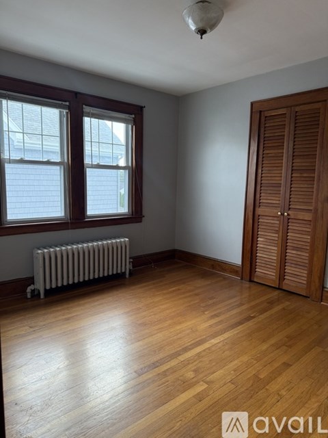 A room with wooden floors and a white ceiling with a light fixture.