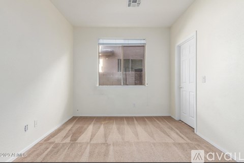A room with a window and a door is available for rent.