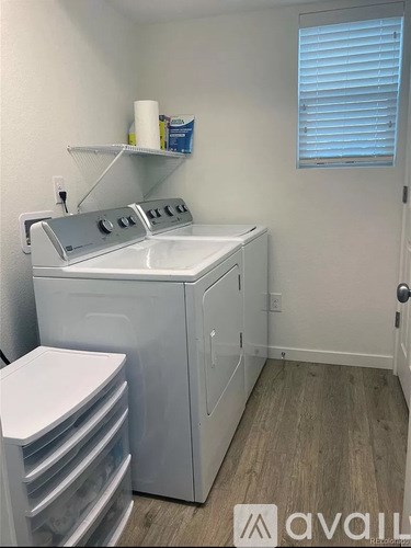 A small laundry room with a washer and dryer.