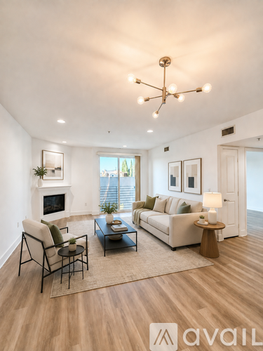 A living room with a fireplace, a sofa, a chair, a coffee table, and a rug.