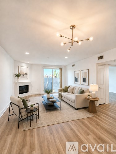 A living room with a fireplace, a sofa, a chair, a coffee table, and a rug.