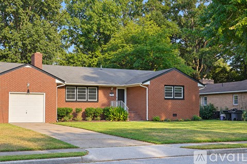 A house with a brick facade and a white garage door.