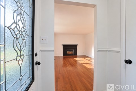 A room with a fireplace and wooden floors.