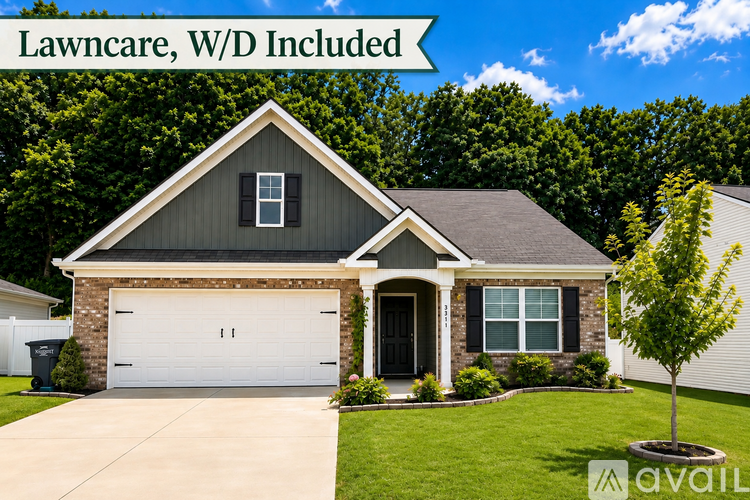 A house with a lawn and a sign that says "Lawncare, W/D Included".