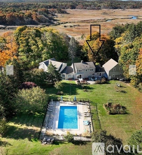 A large house with a pool in the backyard.