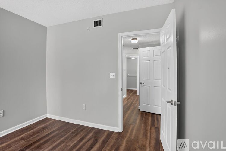 A room with a wooden floor and white walls.