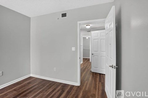 A room with a wooden floor and white walls.